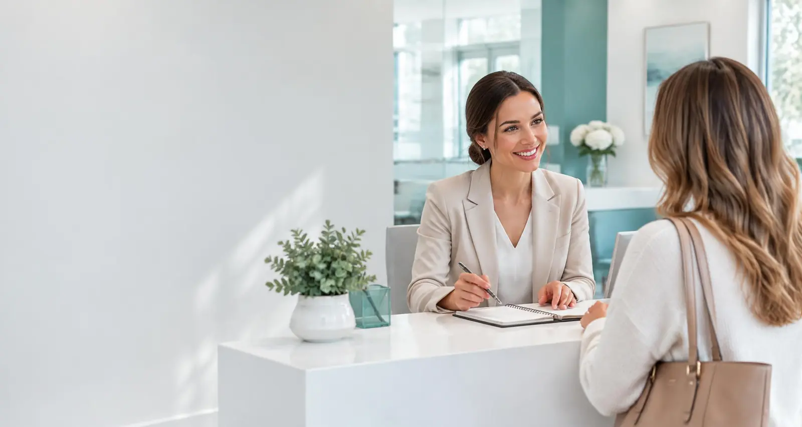 A receptionist welcoming a visitor to a dermatology clinic